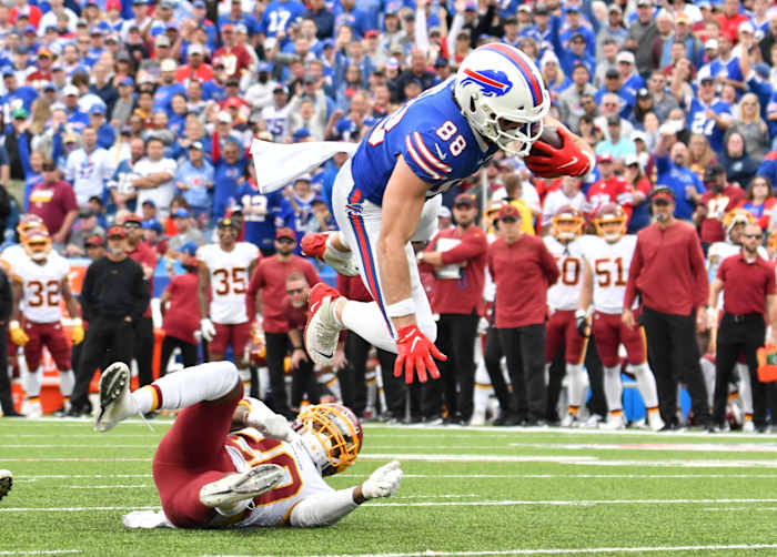 Buffalo Bills tight end Dawson Knox (88) is upended by Washington Football Team cornerback Bobby McCain (20) after making a catch in the fourth quarter at Highmark Stadium.